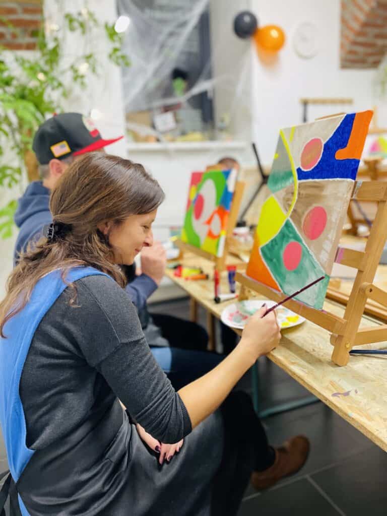 woman smiling while painting