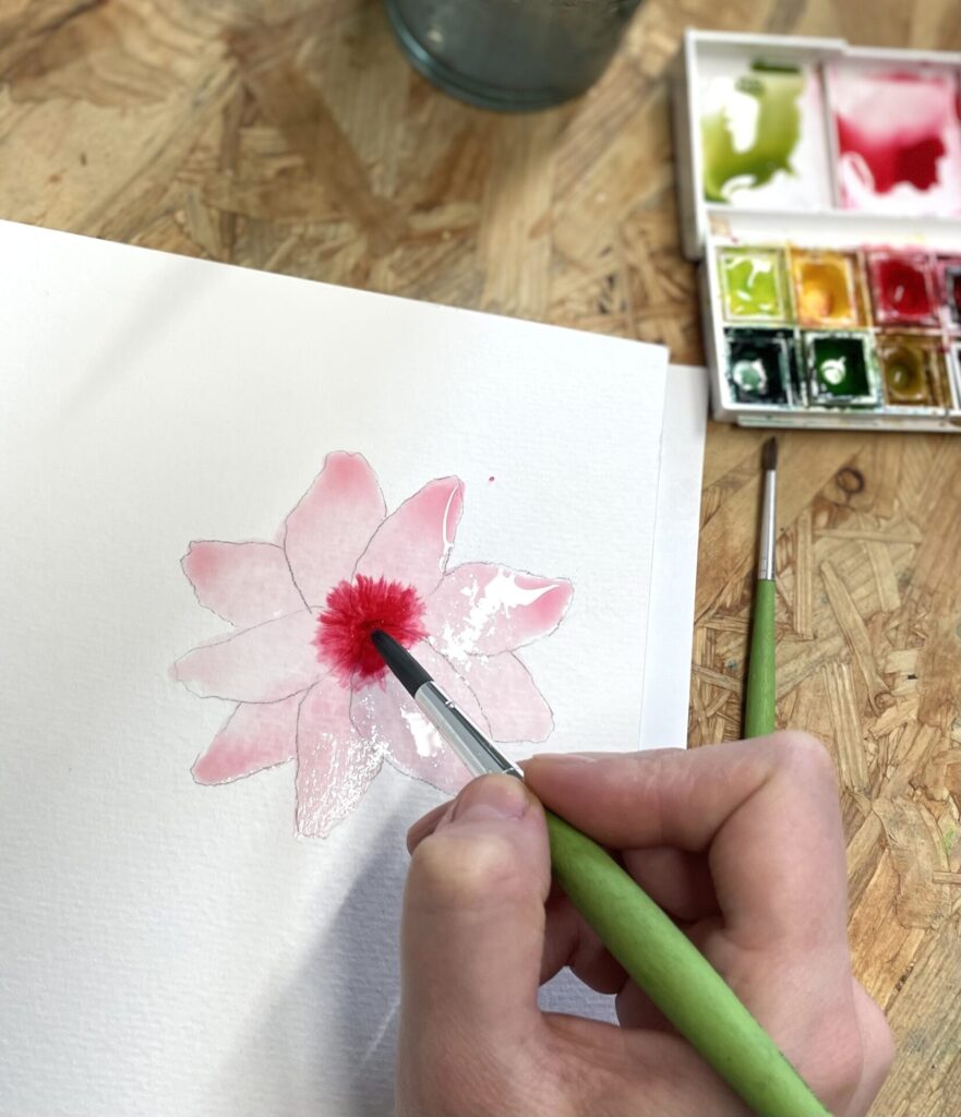hand painting a watercolour flower painting